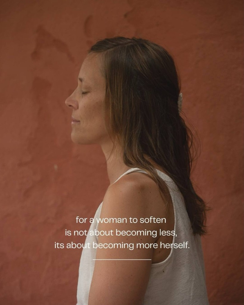 A woman resting with her eyes closed against a warm wall