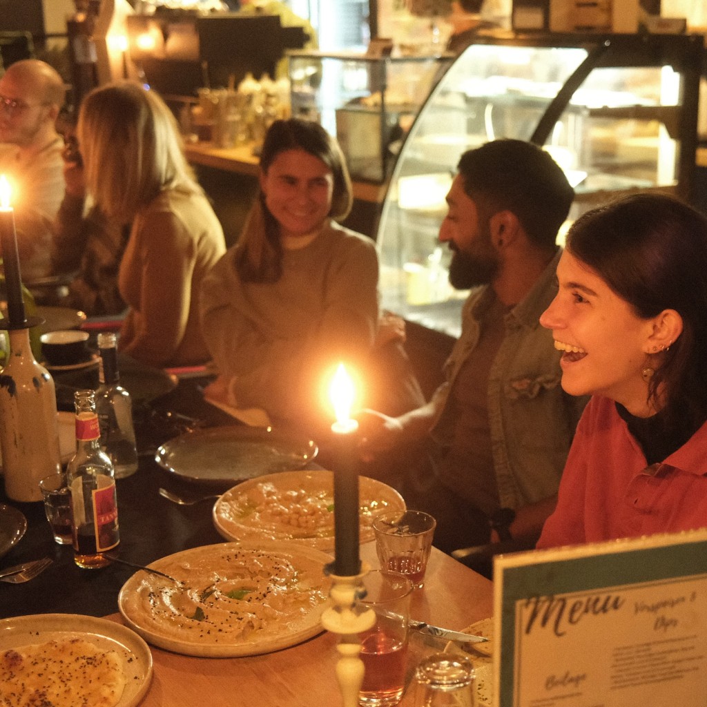 A group gathered around a candlelit table
